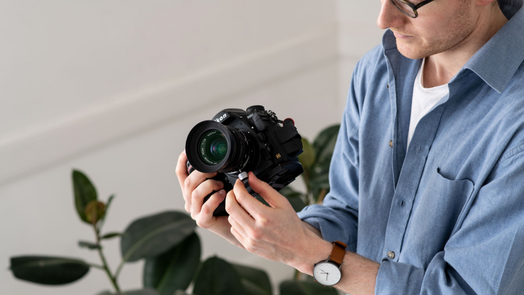 Photographer using architectural shift lens on Nikon camera