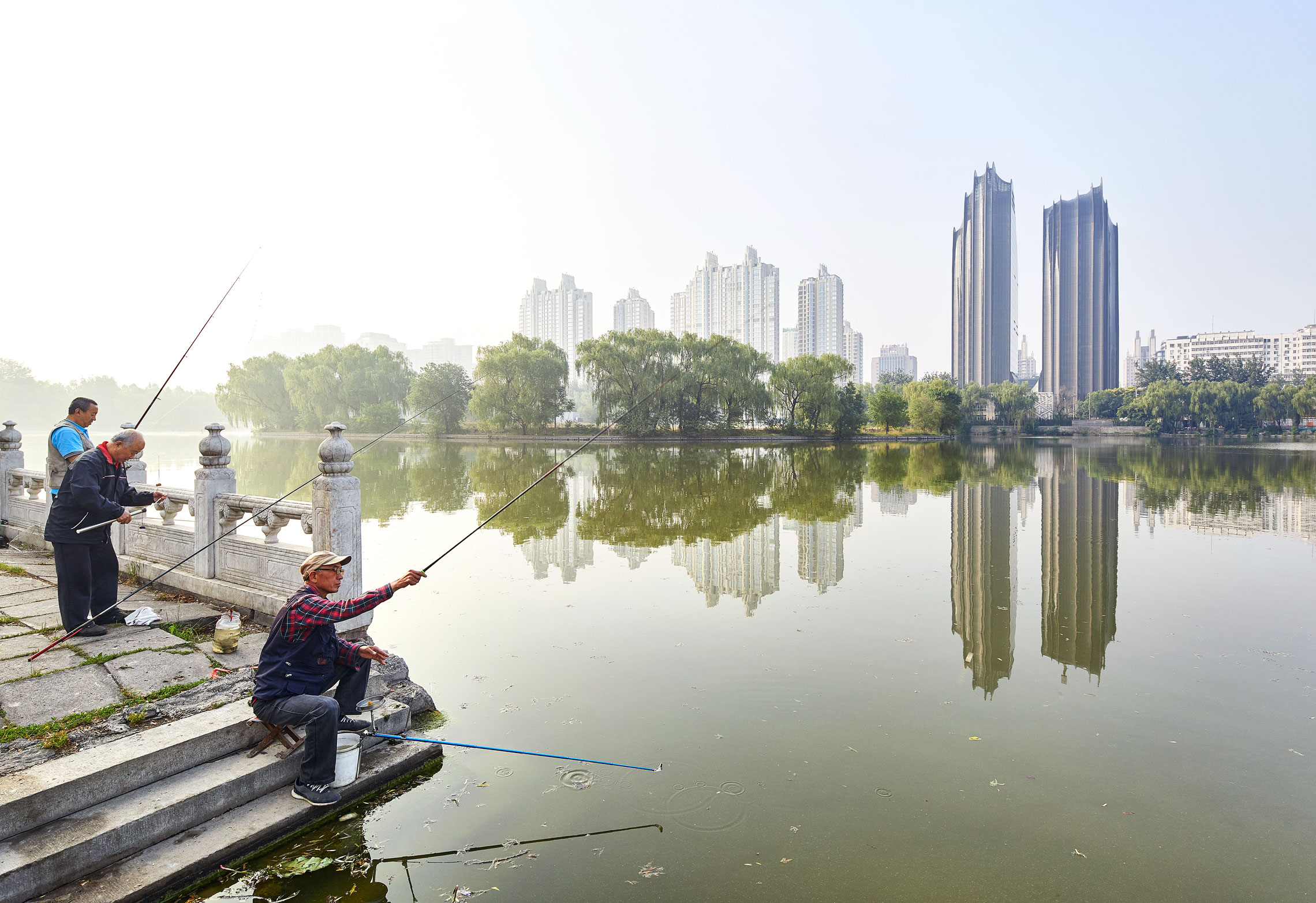 Men Fishing infornt of Chaoyang Park Plaza in Beijing China